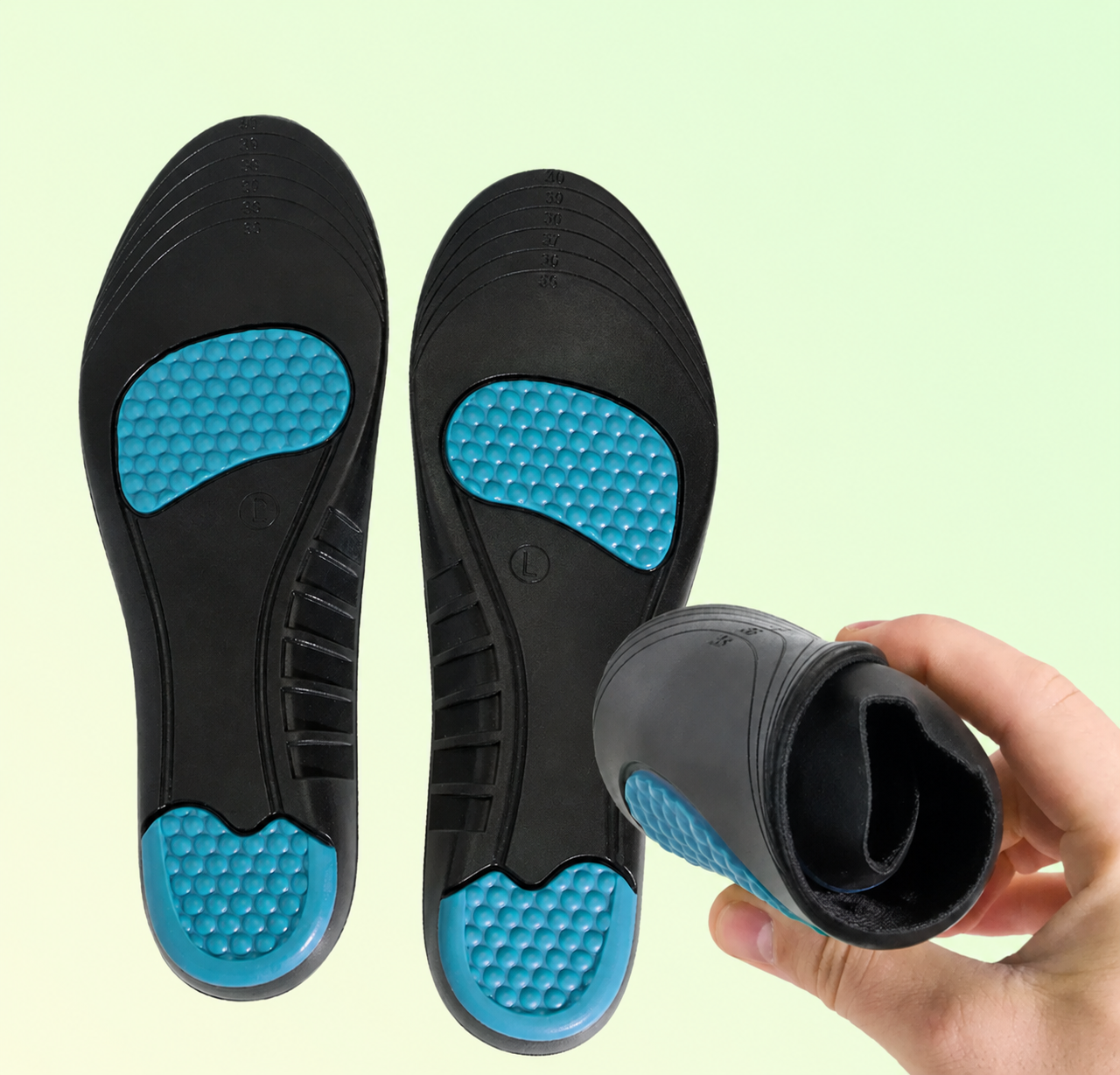 Black and blue shoe inserts with a hand holding one insert against a light green background